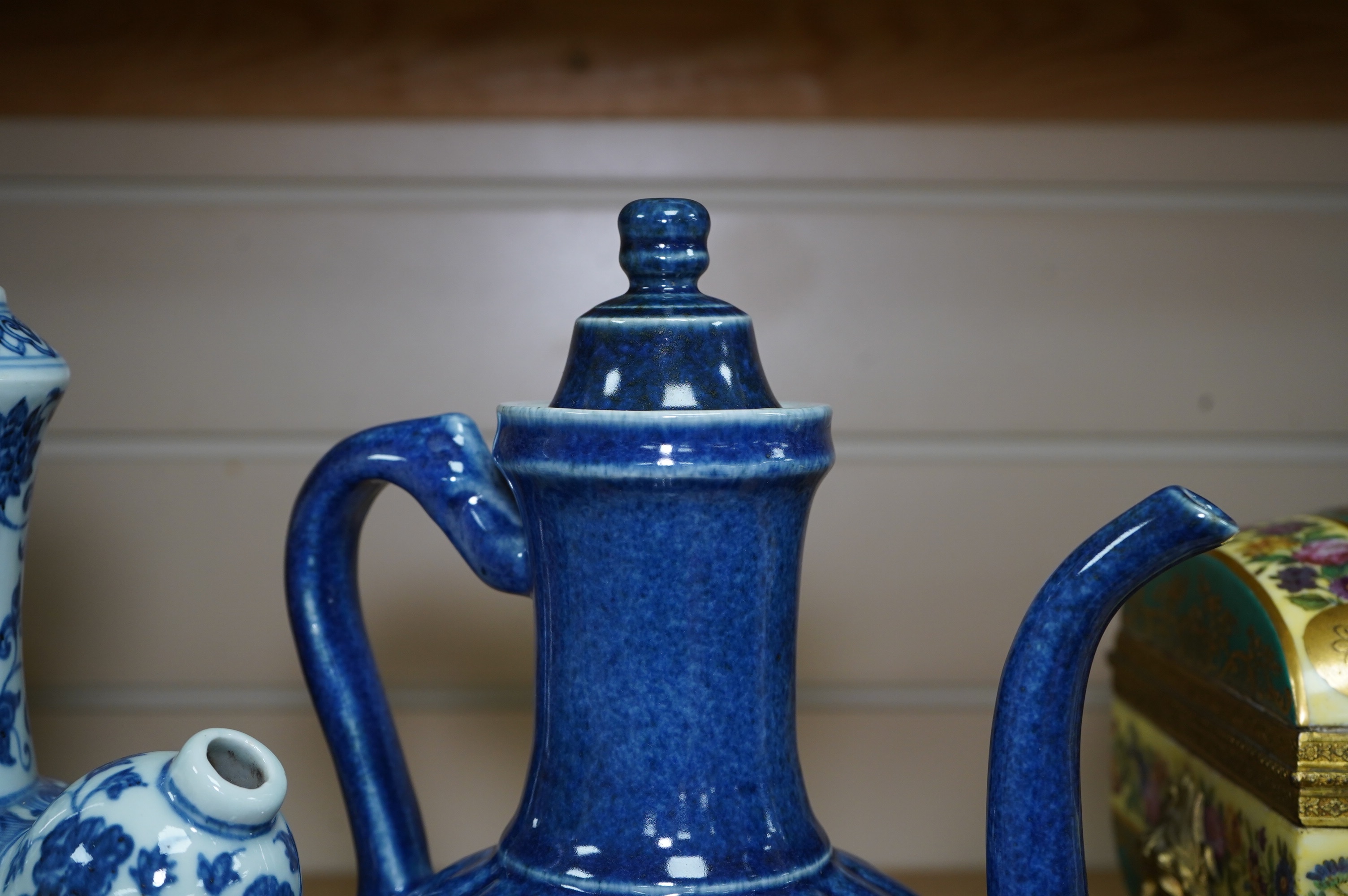 A Chinese porcelain powder blue ewer with cover and a similar blue and white example, largest 25cm high. Condition - good